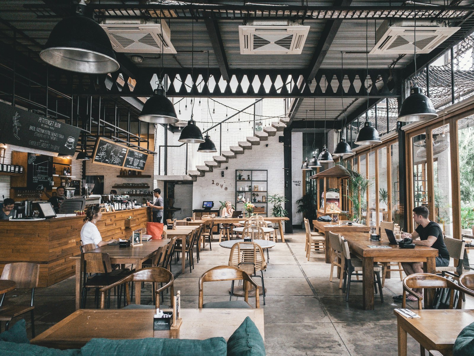 Warm bistro interior with wood tables and soft lamps