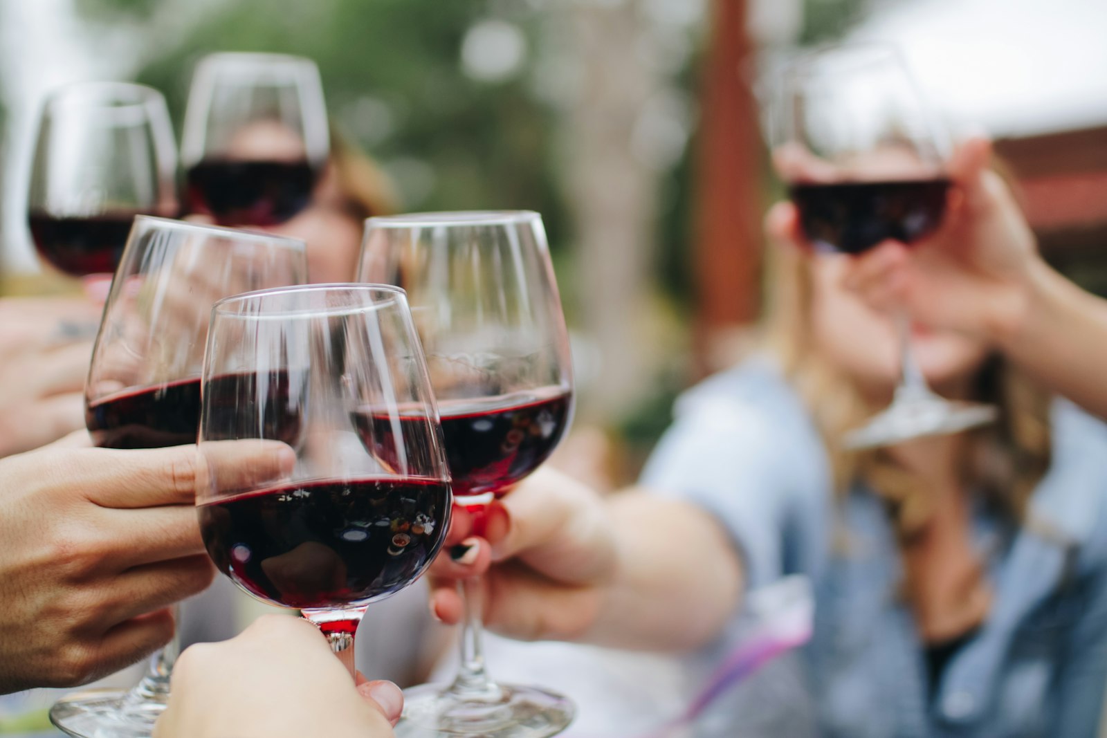 Natural wine poured into glasses on a wooden bar